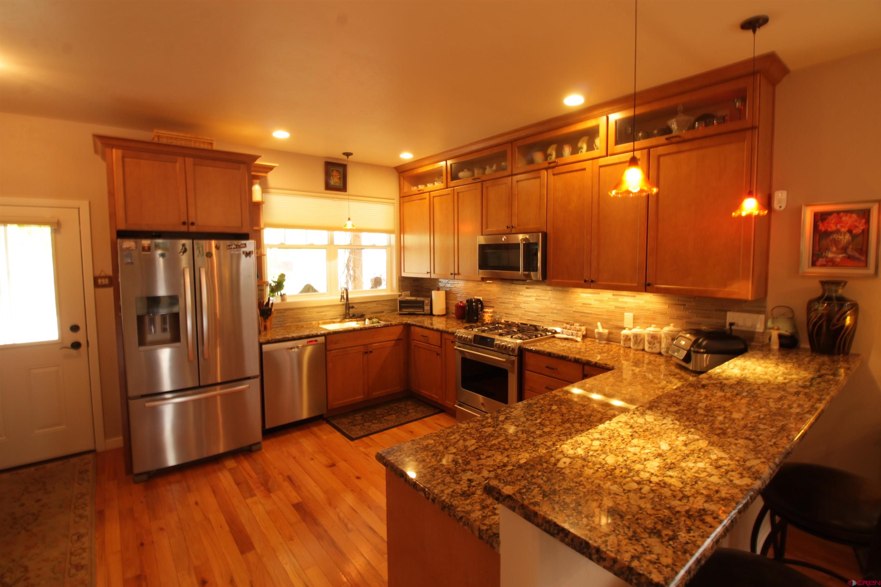 480 Oxbow Circle Durango, CO 81301 - Photo 5 of 16 a kitchen with stainless steel appliances granite countertop a refrigerator a stove and a sink