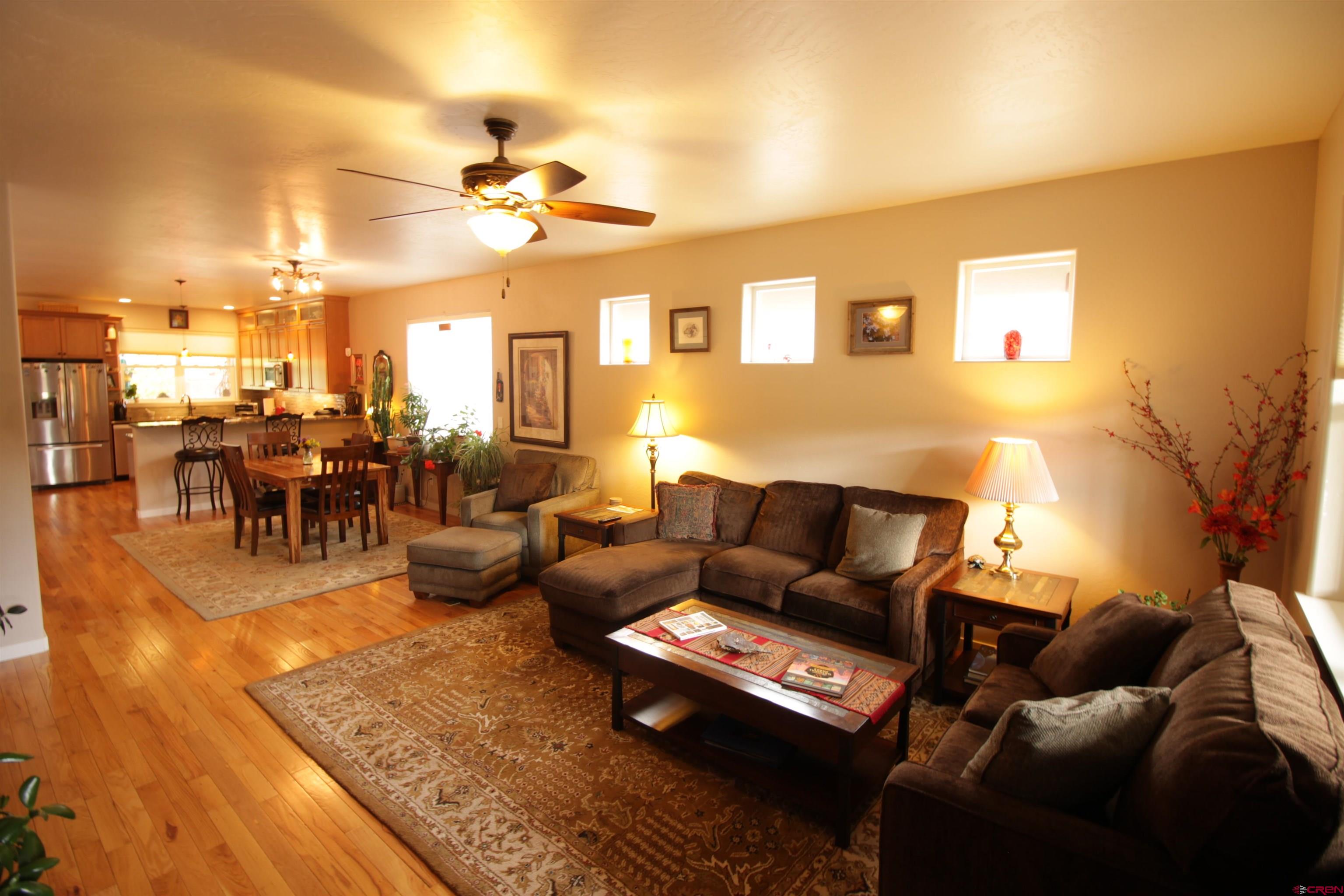 480 Oxbow Circle Durango, CO 81301 - Photo 8 of 16 a living room with furniture a rug and a chandelier