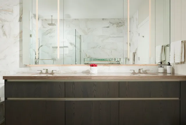 a bedroom with a large window and a balcony