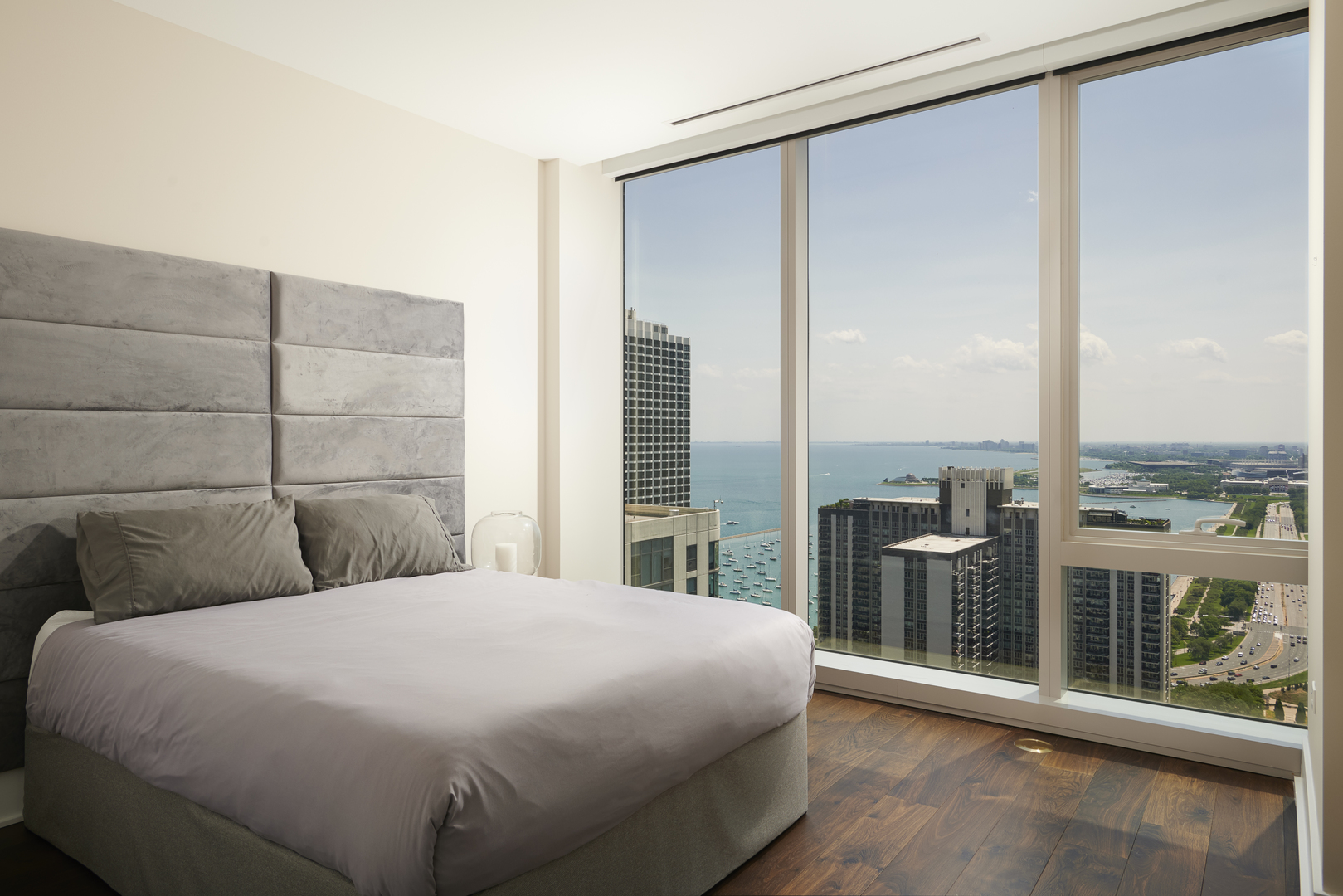 363 East Wacker Drive, Unit 3303 Chicago, IL 60601 - Photo 17 of 31 a bedroom with a large window and a balcony