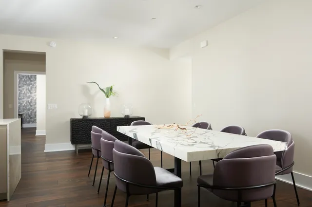 a bedroom with a bed chair and a large window