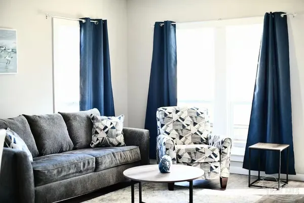 a living room with furniture and a large window