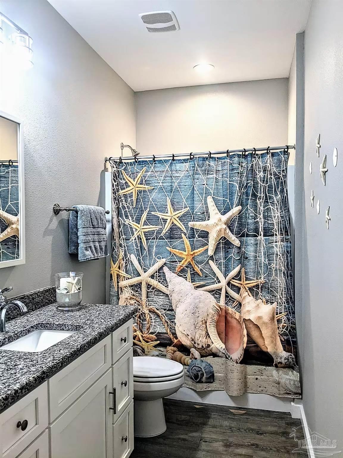 5446 Medina Road Pensacola, FL 32507 - Photo 7 of 11 a bathroom with a granite countertop sink and a toilet