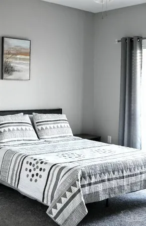 a bedroom with a bed and a window