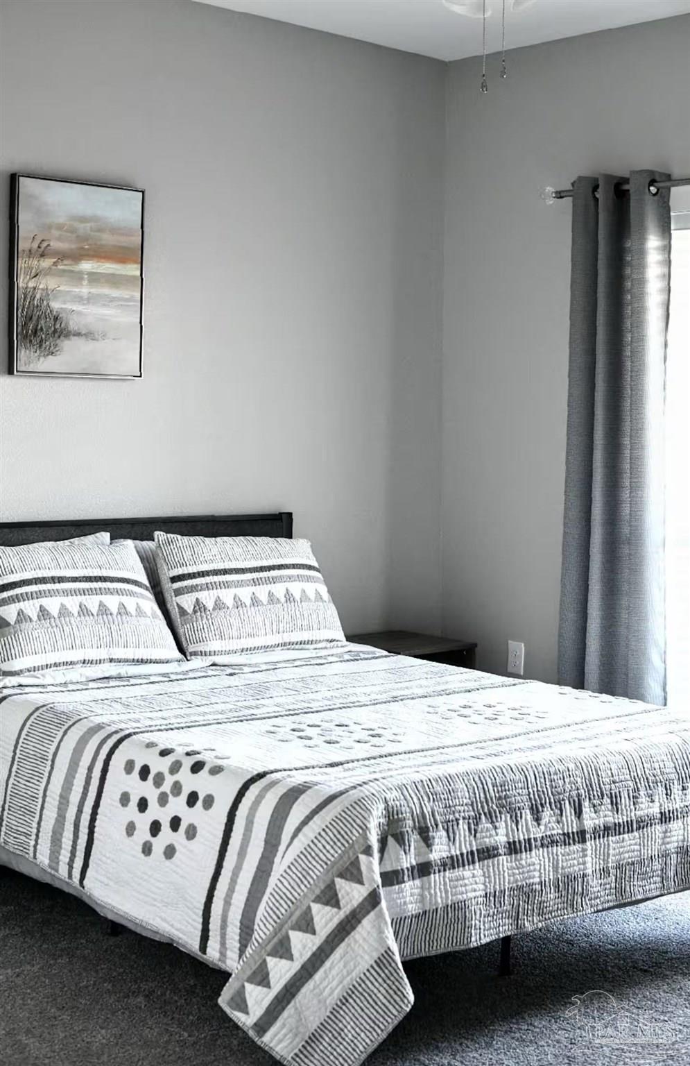 5446 Medina Road Pensacola, FL 32507 - Photo 8 of 11 a bedroom with a bed and a window