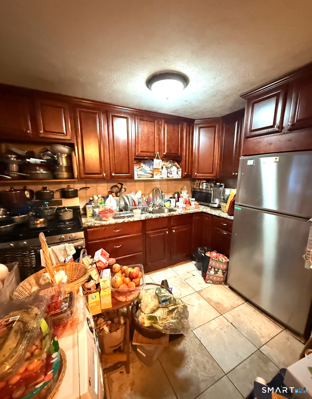 280 Capen Street Hartford, CT 06112 - Photo 5 of 11 a view of a kitchen with kitchen island granite countertop wooden cabinets and a view of living room