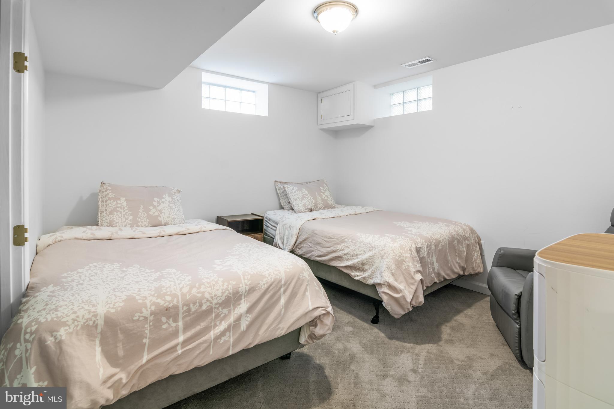 6308 Ivymount Road Baltimore, MD 21209 - Photo 20 of 22 a bedroom with two bed and a window