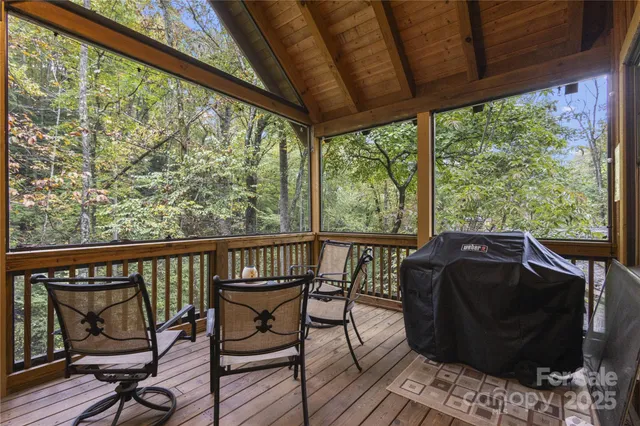 a view of a balcony with furniture and wooden floor