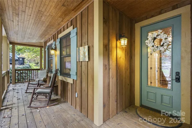 a view of a balcony with furniture and floor to ceiling window
