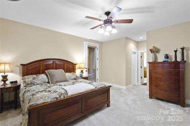 a bedroom with a large bed and a chandelier