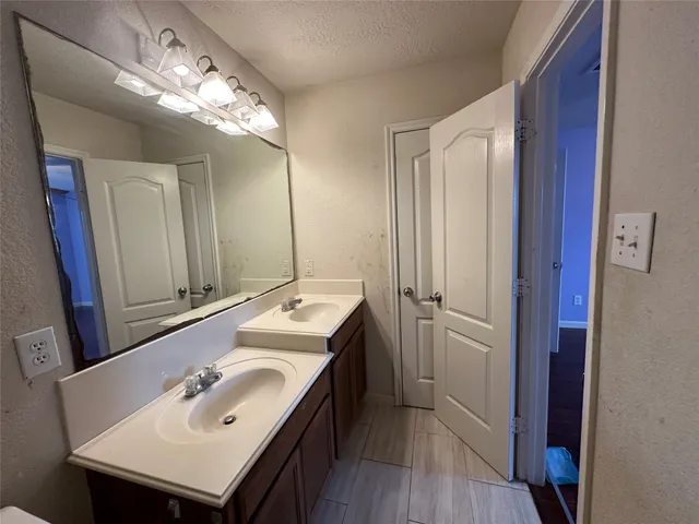 a bathroom with a sink double vanity and a mirror