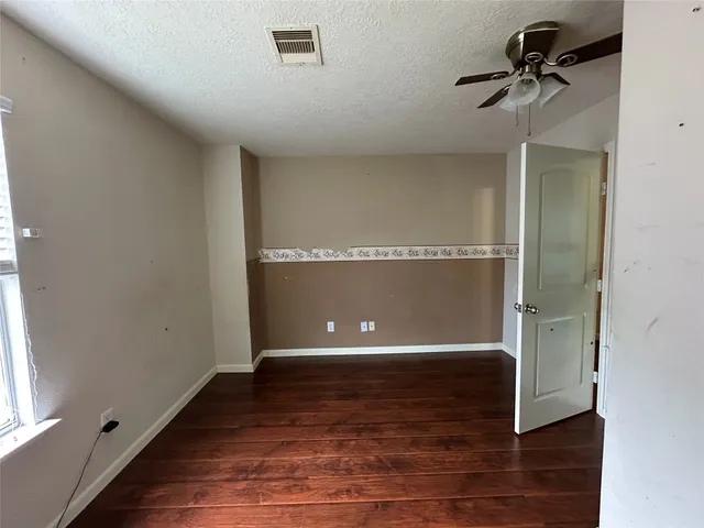 a view of a room with wooden floor