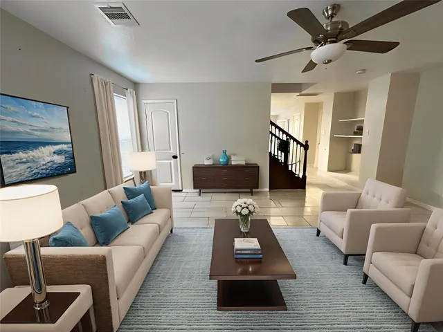 a living room with furniture and a wooden floor