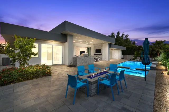 a living room with stainless steel appliances kitchen island granite countertop furniture a flat screen tv and a kitchen view