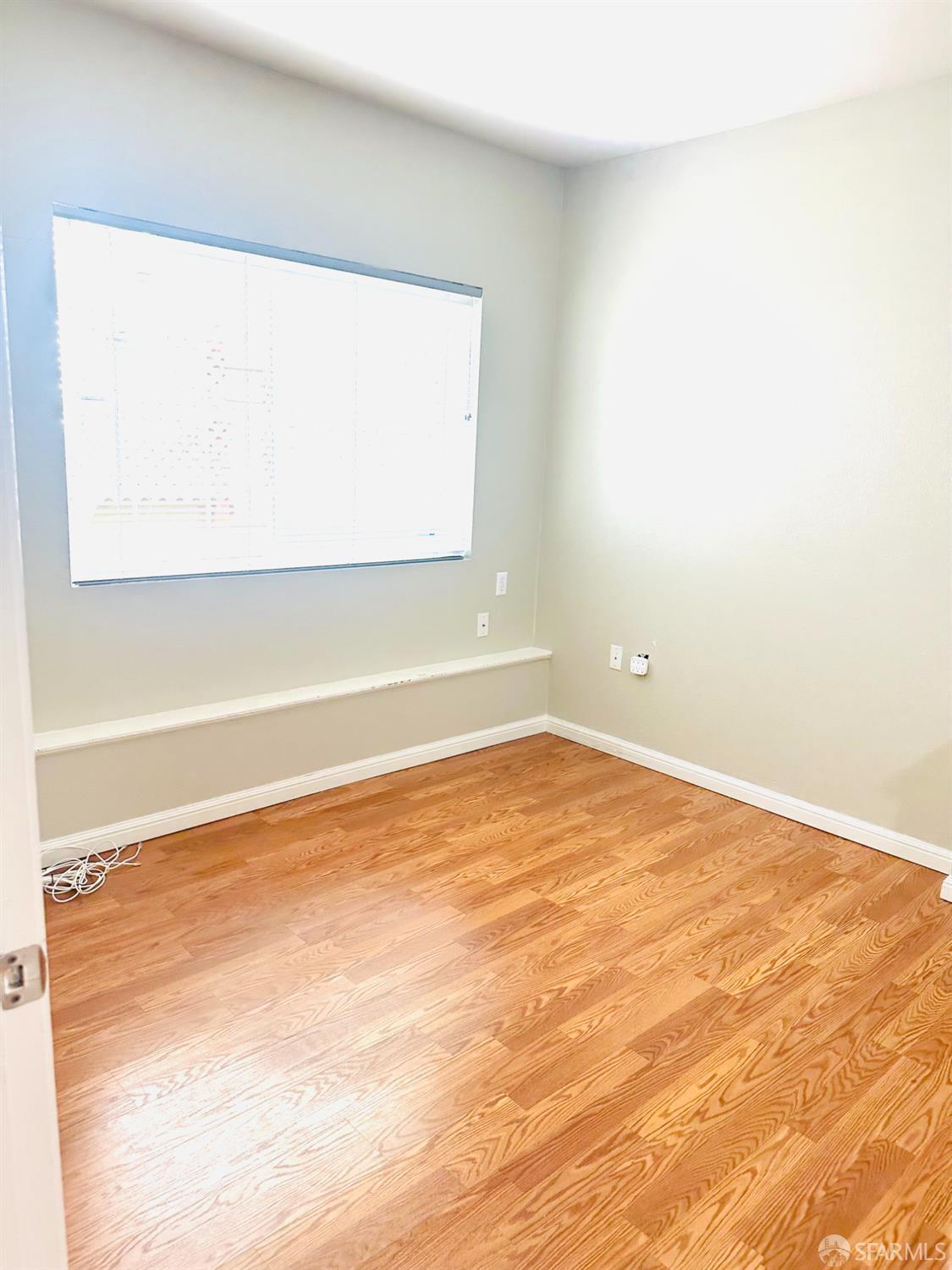 5654 Mission Street San Francisco, CA 94112 - Photo 10 of 15 a view of a room with wooden floor and a window