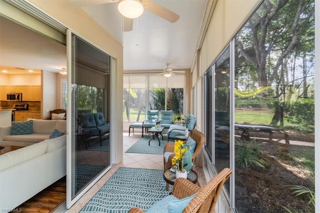 873 Carrick Bend Circle, Unit 101 Naples, FL 34110 - Photo 14 of 42 a view of a porch with chairs and backyard