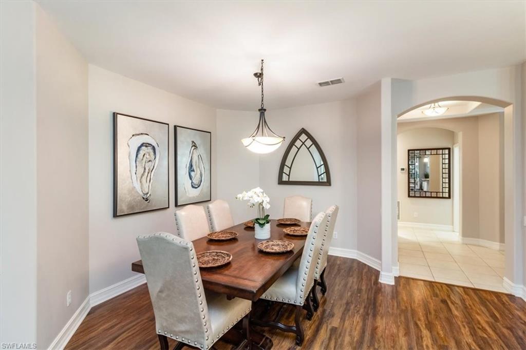 873 Carrick Bend Circle, Unit 101 Naples, FL 34110 - Photo 20 of 42 a view of a dining room with furniture window and wooden floor