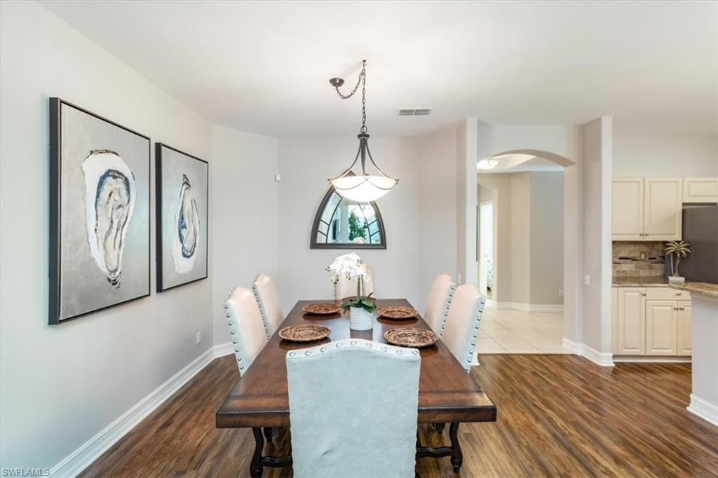 873 Carrick Bend Circle, Unit 101 Naples, FL 34110 - Photo 42 of 42 a living room with furniture and a wooden floor