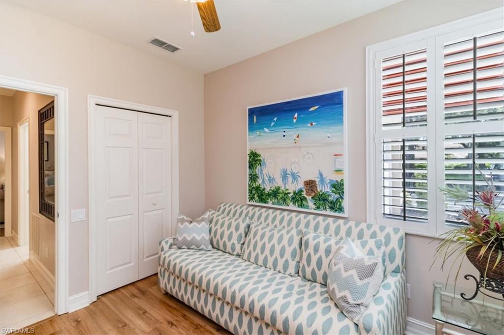 873 Carrick Bend Circle, Unit 101 Naples, FL 34110 - Photo 29 of 42 a living room with furniture and a potted plant