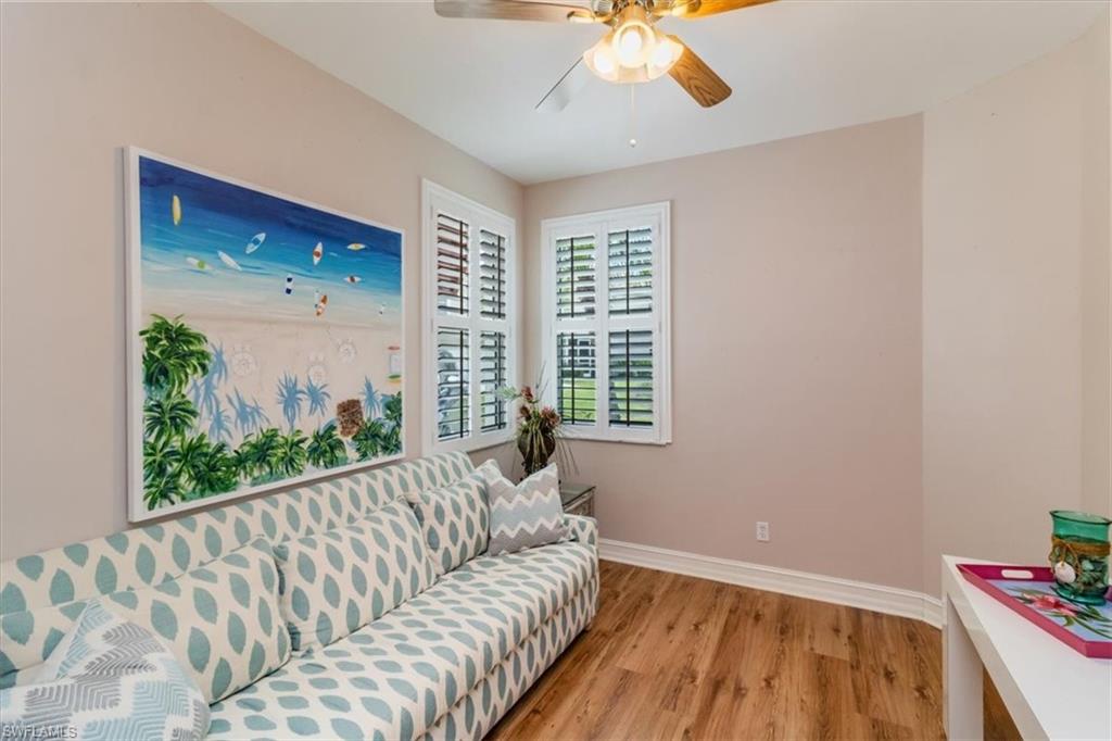 873 Carrick Bend Circle, Unit 101 Naples, FL 34110 - Photo 30 of 42 a living room with furniture and a large window