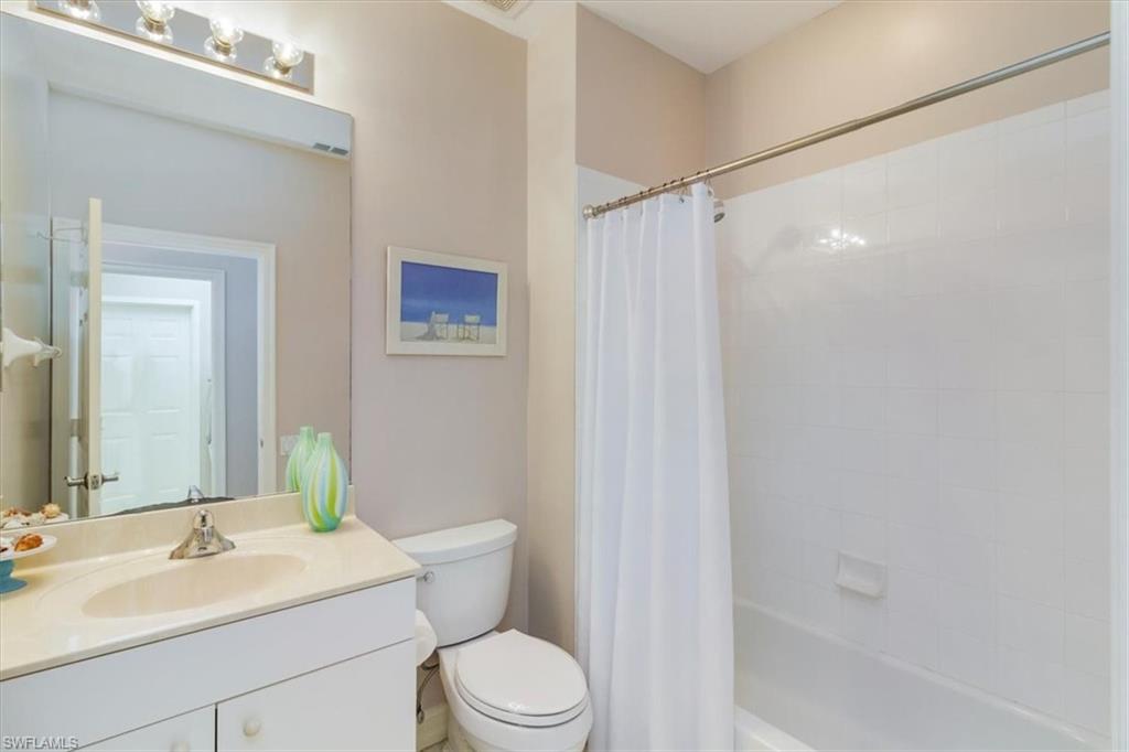 873 Carrick Bend Circle, Unit 101 Naples, FL 34110 - Photo 31 of 42 a bathroom with a sink a toilet and shower