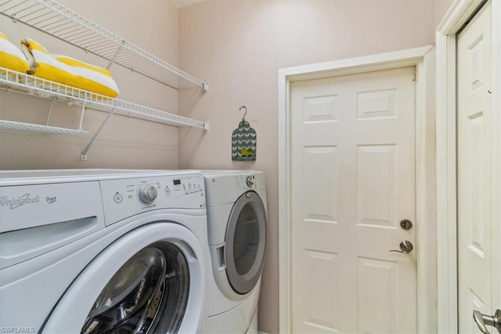 873 Carrick Bend Circle, Unit 101 Naples, FL 34110 - Photo 32 of 42 a utility room with dryer and washer