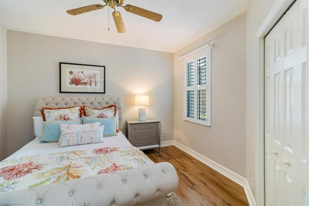 873 Carrick Bend Circle, Unit 101 Naples, FL 34110 - Photo 33 of 42 a bedroom with a bed and a window