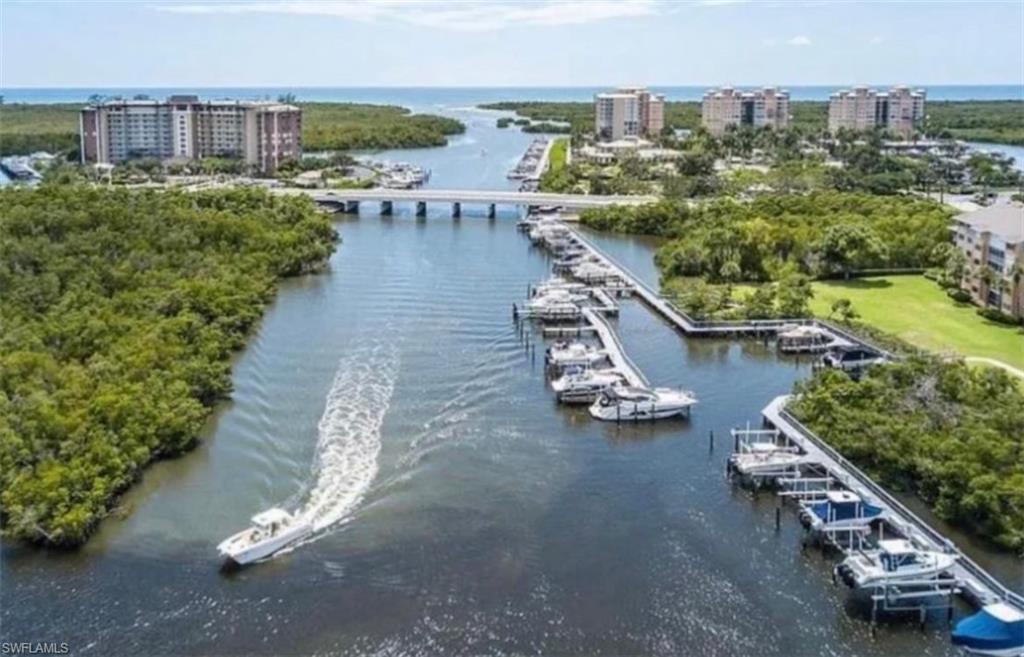 873 Carrick Bend Circle, Unit 101 Naples, FL 34110 - Photo 37 of 42 a view of a city with lawn chairs