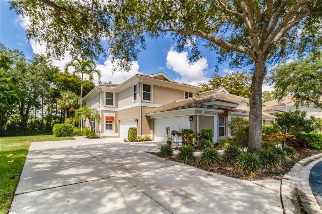 873 Carrick Bend Circle, Unit 101 Naples, FL 34110 - Photo 4 of 42 a front view of a house with a garden