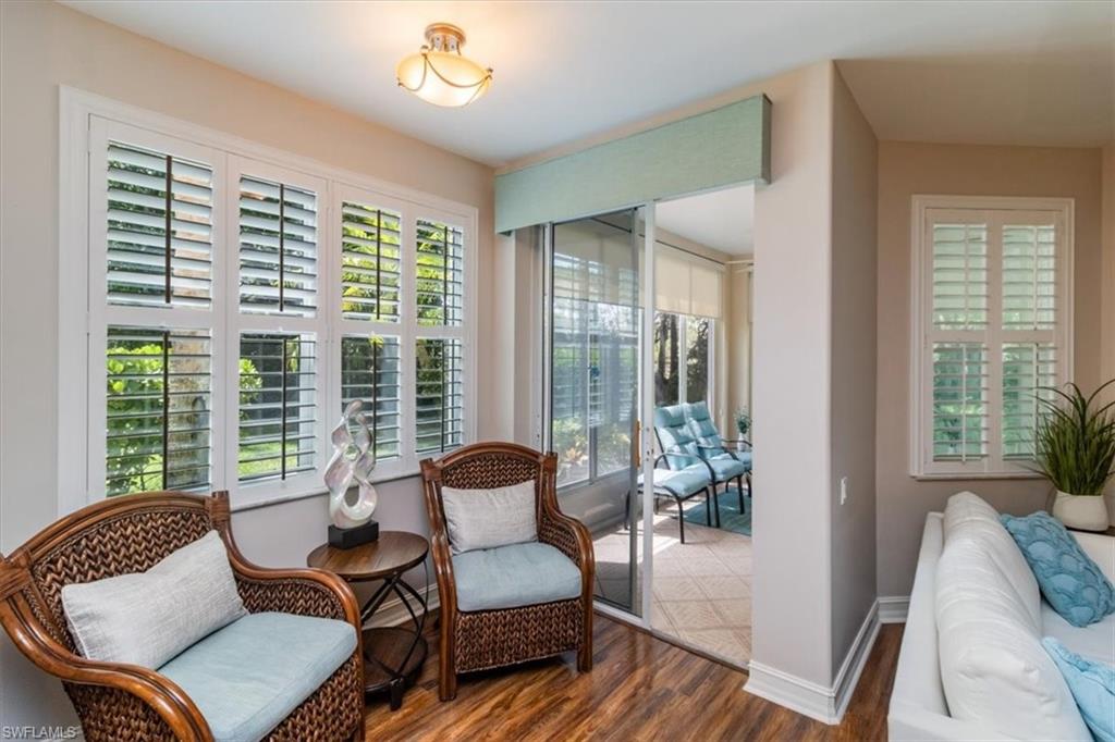 873 Carrick Bend Circle, Unit 101 Naples, FL 34110 - Photo 8 of 42 a living room with furniture and a large window