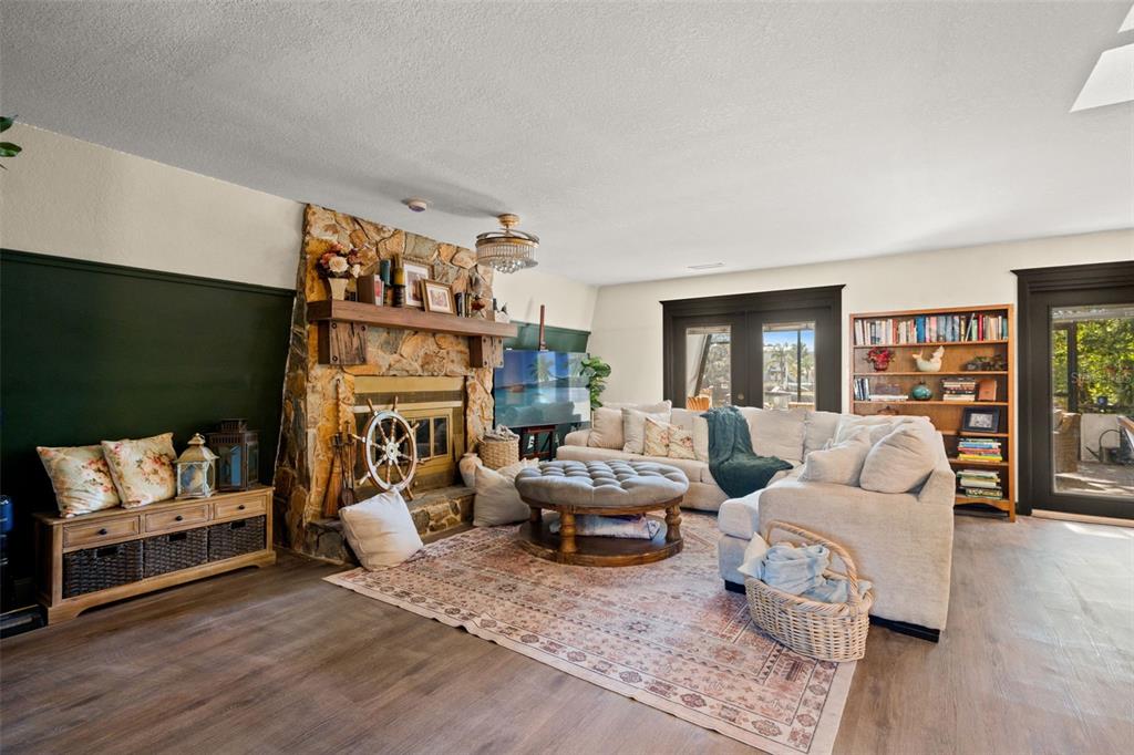 6271 Colony Circle Weeki Wachee, FL 34607 - Photo 11 of 60 a living room with fireplace furniture and a wooden floor