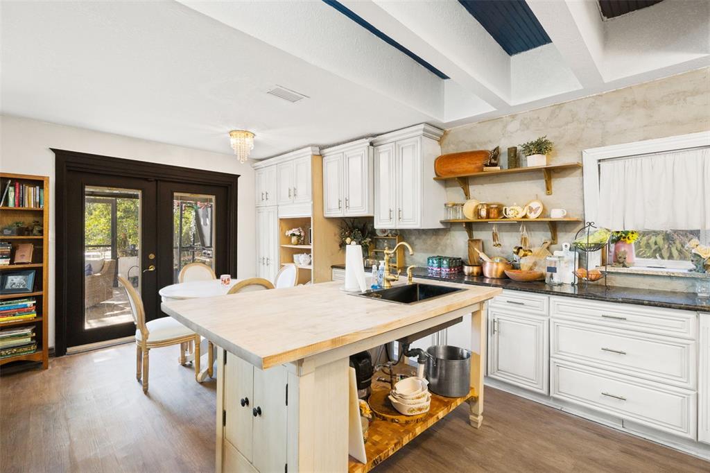 6271 Colony Circle Weeki Wachee, FL 34607 - Photo 23 of 60 a kitchen with a sink a stove and cabinets