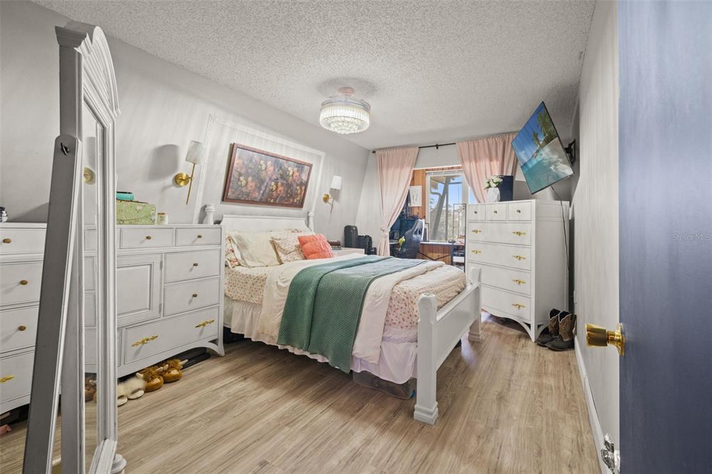 6271 Colony Circle Weeki Wachee, FL 34607 - Photo 33 of 60 a bedroom with a bed and a cabinets