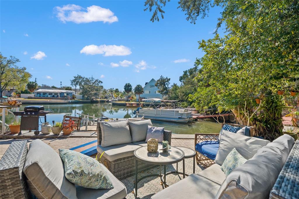 6271 Colony Circle Weeki Wachee, FL 34607 - Photo 45 of 60 a view of a patio with couches table and chairs and potted plants