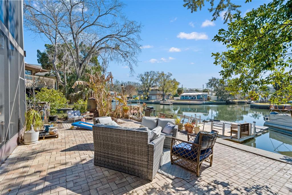 6271 Colony Circle Weeki Wachee, FL 34607 - Photo 46 of 60 a view of a lake with couches and wooden floor