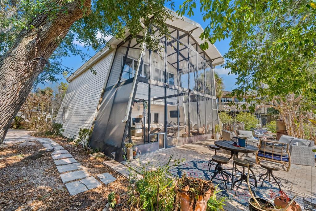 6271 Colony Circle Weeki Wachee, FL 34607 - Photo 49 of 60 a backyard of a house with table and chairs under an umbrella