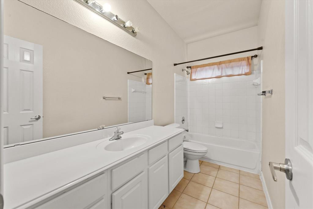 1701 Balboa Lane Allen, TX 75002 - Photo 5 of 30 a bathroom with a sink a toilet and shower