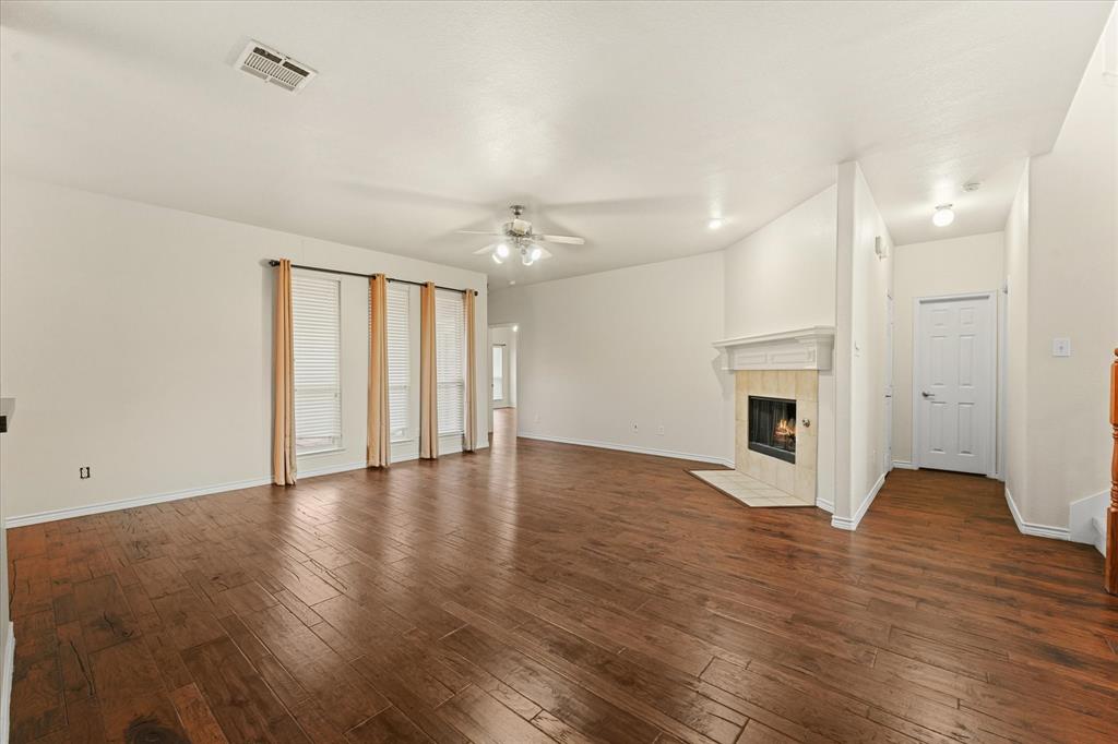 1701 Balboa Lane Allen, TX 75002 - Photo 8 of 30 a view of an empty room with wooden floor and a window