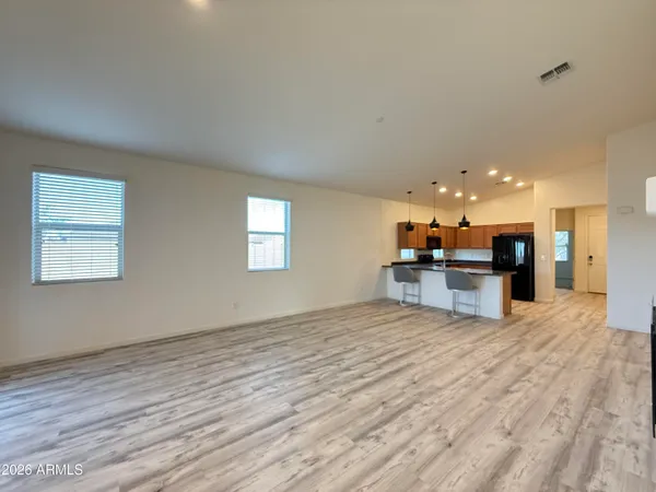 a view of kitchen with kitchen island sink and wooden floor