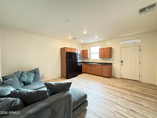 a living room with furniture and kitchen view