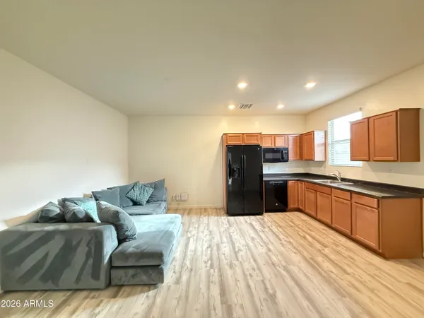 a large room with a couch and wooden floor