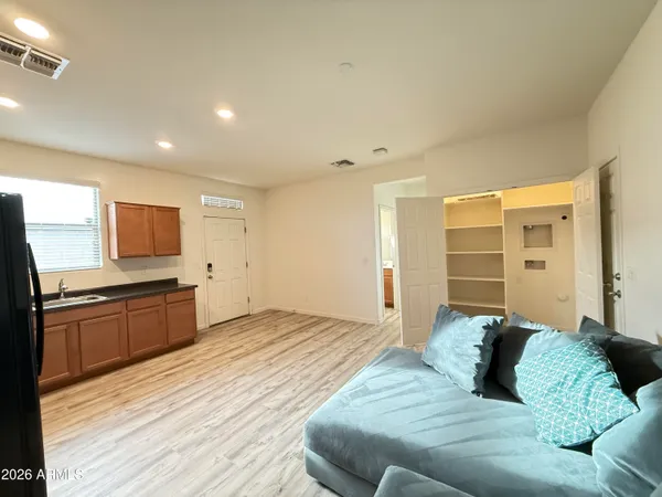 a large bedroom with a bed and a flat screen tv