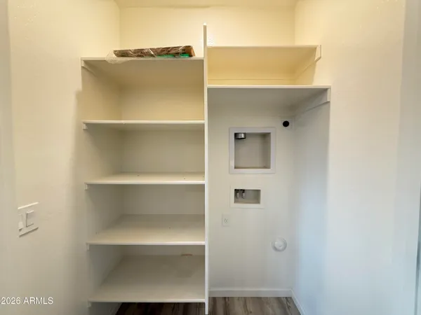 a view of walk in closet with empty racks