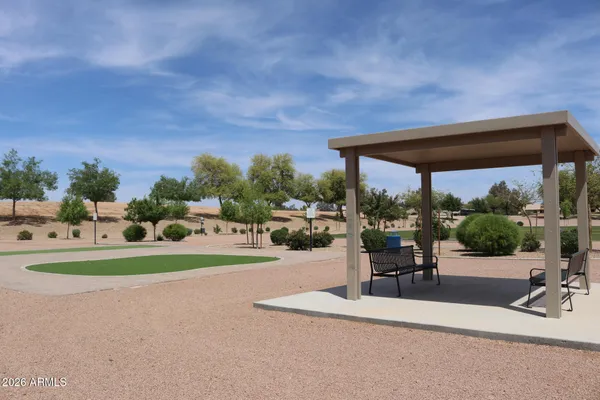 a view of a patio with a table and chairs under an umbrella