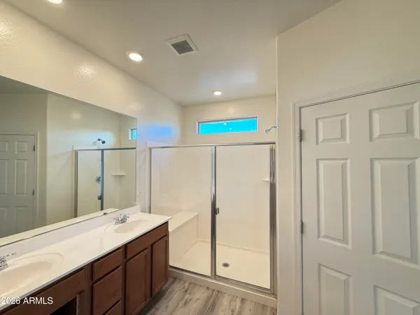 a bathroom with a double vanity sink and a mirror