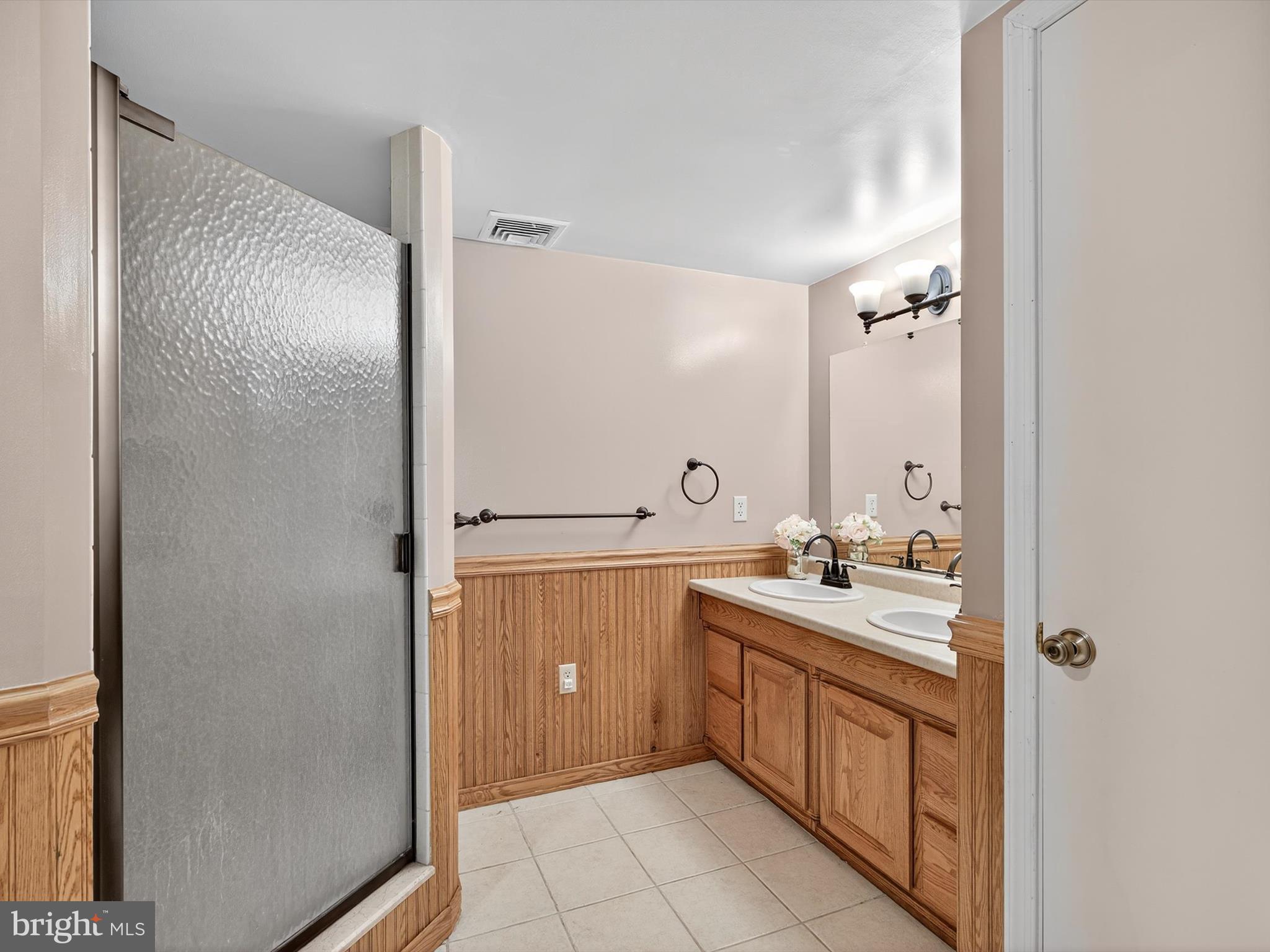 1260 Cider Press Road Manheim, PA 17545 - Photo 56 of 87 a spacious bathroom with a double vanity sink a mirror and a shower