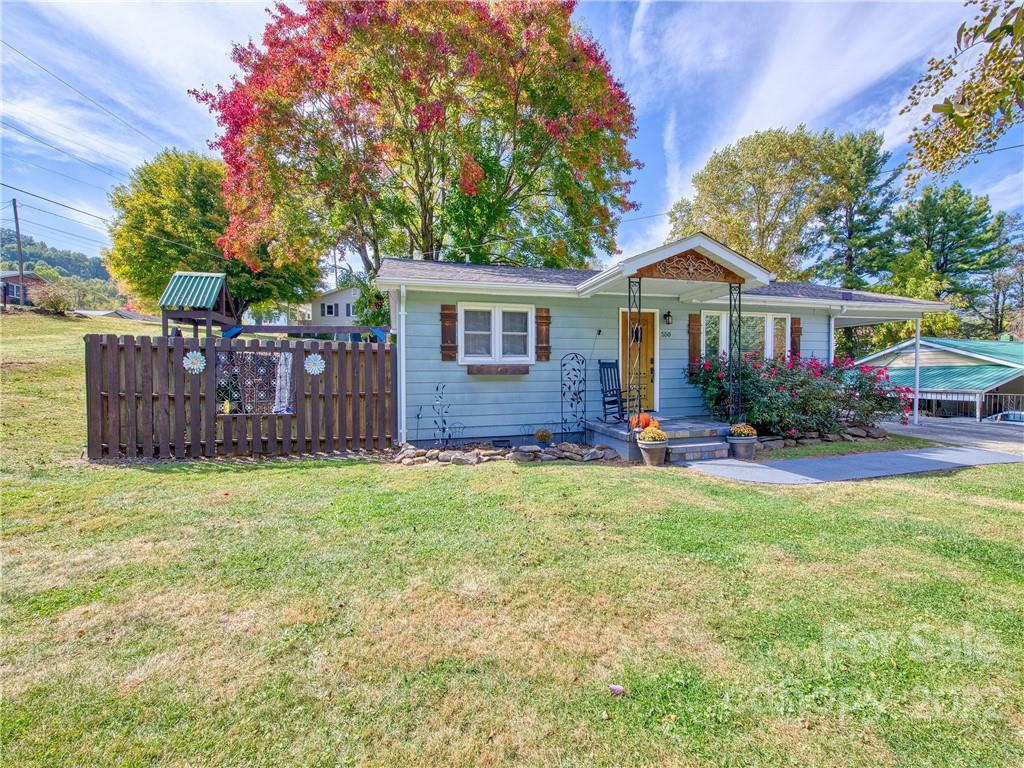 550 Lickstone Road Waynesville, NC 28786 - Photo 1 of 24 a front view of a house with garden