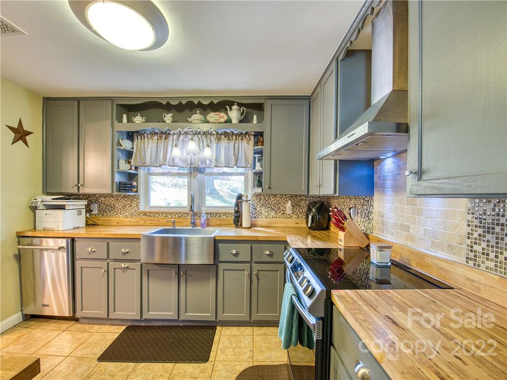 550 Lickstone Road Waynesville, NC 28786 - Photo 14 of 24 a kitchen with a sink and cabinets