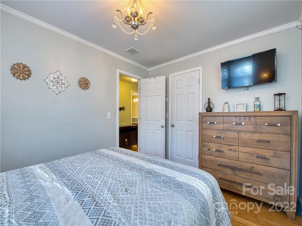 550 Lickstone Road Waynesville, NC 28786 - Photo 17 of 24 a bedroom with a bed and a flat screen tv