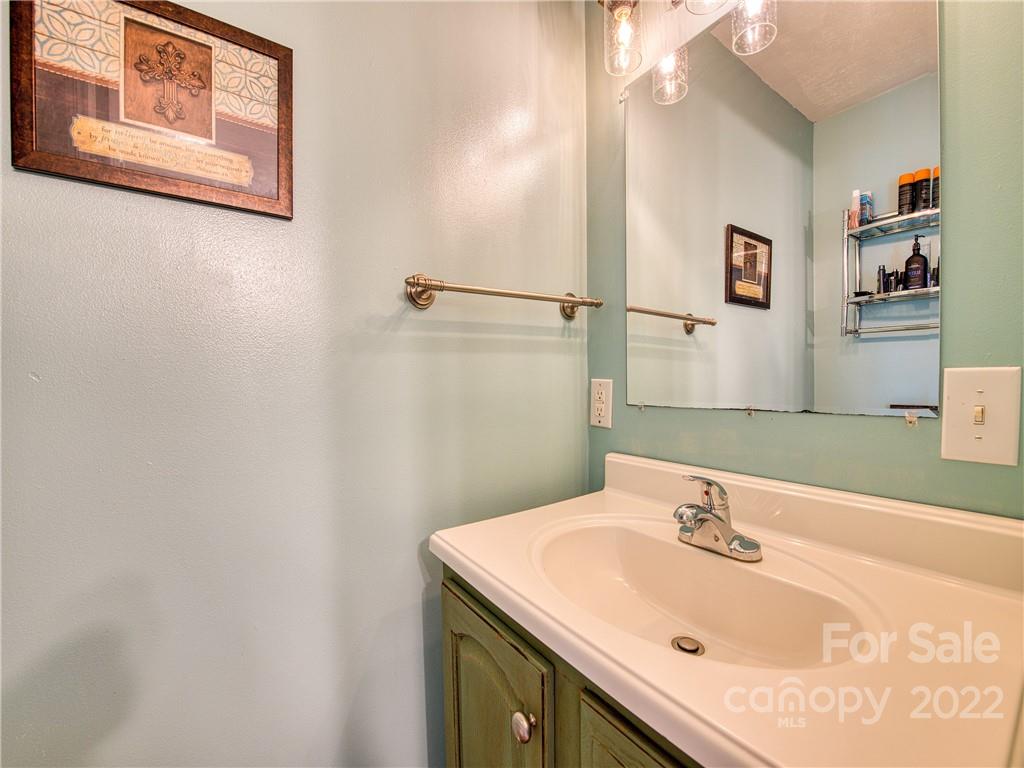 550 Lickstone Road Waynesville, NC 28786 - Photo 19 of 24 a bathroom with a sink and a mirror